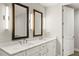 Modern bathroom with double vanity, marble countertop, framed mirrors, and sleek lighting at 270 17Th Nw St # 3604, Atlanta, GA 30363