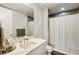 Bathroom with marble countertop, modern vanity, shower with shower curtain, and wall mirror at 270 17Th Nw St # 3604, Atlanta, GA 30363