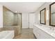 Bathroom featuring a walk-in shower with stone accents and a marble countertop vanity with double sinks at 270 17Th Nw St # 3604, Atlanta, GA 30363