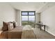 Bright bedroom featuring large windows with stunning city views, plus a decorative table and plush carpet at 270 17Th Nw St # 3604, Atlanta, GA 30363