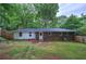 The backyard features a brick house with green grass and partial fence surround at 3647 Miller St, Lithia Springs, GA 30122