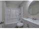 This bathroom features a shower-tub combo, toilet, and a round mirror over the vanity at 3647 Miller St, Lithia Springs, GA 30122