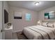 Neutral bedroom with a large bed, dresser, a painting, and a sunny window at 3647 Miller St, Lithia Springs, GA 30122