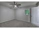 This bedroom features new carpeting, a window, and a ceiling fan with light at 3647 Miller St, Lithia Springs, GA 30122