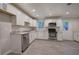 Bright kitchen features stainless steel appliances, white cabinets, gray wood-look floors, and granite countertops at 3647 Miller St, Lithia Springs, GA 30122