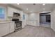 This kitchen is equipped with stainless steel appliances, white cabinets, gray wood-look floors and a large window at 3647 Miller St, Lithia Springs, GA 30122