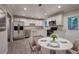 Modern kitchen featuring white cabinets, stainless steel appliances, and an adjacent dining area at 3647 Miller St, Lithia Springs, GA 30122