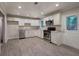 Bright kitchen with white cabinets, stainless steel appliances, and gray vinyl flooring at 3647 Miller St, Lithia Springs, GA 30122