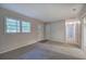 A versatile empty room, carpeted with a view of the front door and hallway at 3647 Miller St, Lithia Springs, GA 30122