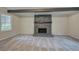 Spacious living room featuring a stone fireplace and bright natural light from large windows at 3647 Miller St, Lithia Springs, GA 30122