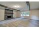 Open living room featuring a stone fireplace, wood beams, and carpeted floors at 3647 Miller St, Lithia Springs, GA 30122