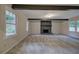 Spacious living room with stone fireplace, wood beams, and bright natural light at 3647 Miller St, Lithia Springs, GA 30122