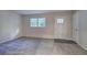 A versatile empty room, carpeted with a view of the front door at 3647 Miller St, Lithia Springs, GA 30122
