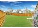 Large backyard featuring a well-maintained lawn and a wooden fence for privacy at 403 Aristides Way, Canton, GA 30115