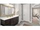 Elegant bathroom featuring a large mirror, modern vanity, and access to the main bedroom at 403 Aristides Way, Canton, GA 30115