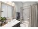 Elegant bathroom featuring a shower-tub, vanity with dark cabinets and framed mirror at 403 Aristides Way, Canton, GA 30115
