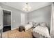 Comfortable bedroom featuring neutral colors, two cozy beds, and a stylish chandelier at 403 Aristides Way, Canton, GA 30115