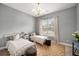 Cozy bedroom with two twin beds, neutral decor, and natural light from a window at 403 Aristides Way, Canton, GA 30115