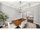 Elegant dining room with coffered ceilings, modern chandelier, and a large wood dining table at 403 Aristides Way, Canton, GA 30115