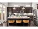 Open kitchen with granite counters, island seating, and stainless appliances at 403 Aristides Way, Canton, GA 30115
