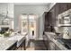 Modern kitchen featuring stainless steel appliances, granite countertops, and a view into the living area at 403 Aristides Way, Canton, GA 30115