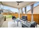 Inviting covered patio with modern seating, a ceiling fan, and a view of the fenced backyard at 403 Aristides Way, Canton, GA 30115