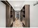 Spacious walk-in closet with wood shelving on both sides and a decorative rug at 403 Aristides Way, Canton, GA 30115