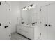 Modern white bathroom featuring a double sink vanity, large mirror, and recessed lighting at 907 Edgewood Ave, Atlanta, GA 30307