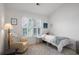 Inviting bedroom featuring a cozy armchair, plush rug, and a bright window with shutters at 907 Edgewood Ave, Atlanta, GA 30307