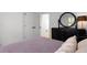 Inviting bedroom with hardwood floors, black dresser, and a large mirror at 907 Edgewood Ave, Atlanta, GA 30307