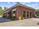 Brick corner building featuring an open storefront with modern signage and a well-maintained parking area at 907 Edgewood Ave, Atlanta, GA 30307
