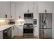 Updated kitchen features stainless steel appliances and bright white cabinets at 907 Edgewood Ave, Atlanta, GA 30307