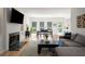 Bright and airy living room featuring a fireplace, hardwood floors, and open layout to the dining area at 907 Edgewood Ave, Atlanta, GA 30307