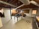 Open basement space with exposed ductwork, concrete floor, and work tables along the walls at 9214 Brave Ct, Jonesboro, GA 30236