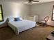 Spacious bedroom with a queen bed, crib, rocking chair, and natural light at 9214 Brave Ct, Jonesboro, GA 30236