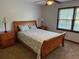 Cozy bedroom with wooden furniture, bedside lamps, and a view of the backyard at 9214 Brave Ct, Jonesboro, GA 30236