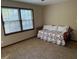 Comfortable bedroom featuring a twin bed, large windows, and a ceiling fan at 9214 Brave Ct, Jonesboro, GA 30236