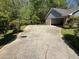 Long concrete driveway leading to the garage of a single-Gathering home, surrounded by greenery at 9214 Brave Ct, Jonesboro, GA 30236