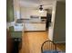 Traditional kitchen with white cabinets, hardwood flooring, and modern appliances at 9214 Brave Ct, Jonesboro, GA 30236