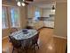 Spacious eat-in kitchen with white cabinets, hardwood floors and natural lighting at 9214 Brave Ct, Jonesboro, GA 30236