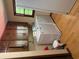Laundry room with stacked washer/dryer and storage cabinets at 9214 Brave Ct, Jonesboro, GA 30236