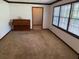 Spacious living room with hardwood floors, plenty of natural light, and a piano at 9214 Brave Ct, Jonesboro, GA 30236