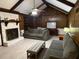 Spacious living room with vaulted ceiling, wood paneling, and a stone fireplace at 9214 Brave Ct, Jonesboro, GA 30236