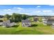 Spacious backyard with lush lawn and scenic views of the home, neighboring houses, and surrounding trees at 1139 Blue Juniper Cir, Loganville, GA 30052