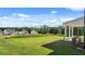 Large backyard with a well-maintained lawn and view from the covered porch of neighboring houses and trees at 1139 Blue Juniper Cir, Loganville, GA 30052