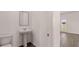 Cozy half-bathroom featuring a single sink and a toilet in a well-lit space at 1139 Blue Juniper Cir, Loganville, GA 30052