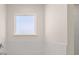 Well-lit bathroom with white subway tile and a window above the bathtub at 1139 Blue Juniper Cir, Loganville, GA 30052