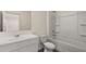 Bright bathroom with white cabinets, a sink, toilet, and a shower/tub combo at 1139 Blue Juniper Cir, Loganville, GA 30052