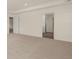 Spacious carpeted bedroom featuring a tray ceiling and doorways to adjacent rooms at 1139 Blue Juniper Cir, Loganville, GA 30052