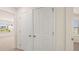 Hallway closet with paneled doors, adjoining rooms and bright window at 1139 Blue Juniper Cir, Loganville, GA 30052